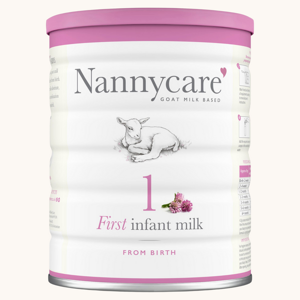 Nannycare First Infant Milk 1 (900g) is a goat milk-based formula suitable from birth. The packaging shows a baby goat and a pink flower, with pink and grey accents.