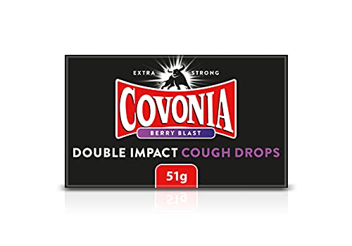 Covonia Double Impact Cough Drops Berry Blast (51g) boasts a striking black package with a red and white logo, accented by white and purple text. Branded Extra Strong, these mentholated drops offer robust flavors for effective relief.