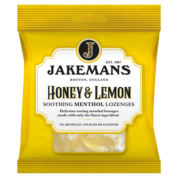 A yellow packet of Jakemans Honey & Lemon Soothing Menthol Lozenges features a vintage-style label with Est. 1907 and Boston, England. The menthol lozenges are visible through a clear window, promising timeless relief.