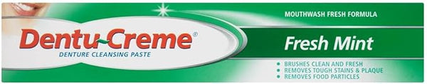 The Dentu Creme (75mL) by Dentu-Creme features green and white packaging highlighting its Fresh Mint flavor and its capabilities in brushing clean, removing stains, plaque, and food particles for effective denture cleaning and bacterial plaque removal.