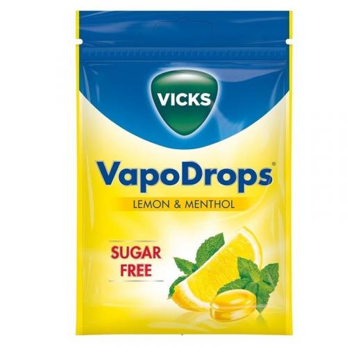 The Vicks Vapodrops Lemon & Menthol Sugar Free (72g) package, in yellow and blue, is ideal for soothing sore throats. It prominently features SUGAR FREE in red and an image of lemon slices with mint leaves.