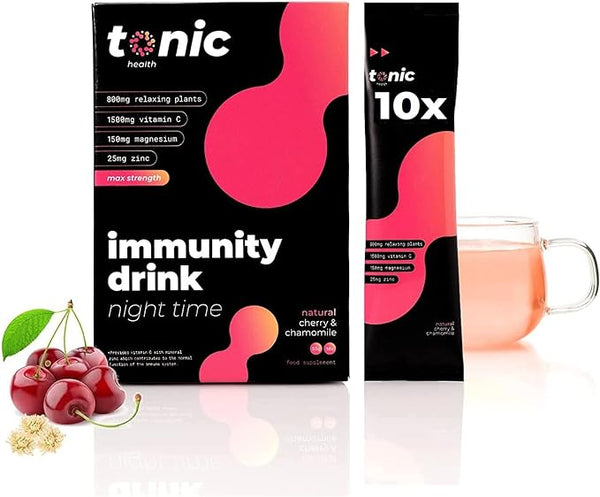 The Tonic Night Time Immunity Drink from Tonic Health is packaged in a black and red box emphasizing natural immunity support with vitamin C, magnesium, and zinc. A sachet stands by a clear mug of the drink, with cherries and chamomile flowers enhancing sleep quality in the foreground.