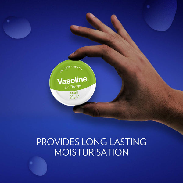 A hand holds a small container of Vaseline Lip Therapy Aloe (20g) against a blue background. Water droplets are scattered around, with text at the bottom reading, PROVIDES LONG LASTING MOISTURISATION for dry lips.