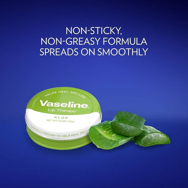 A 20g Vaseline Lip Therapy Aloe container sits beside aloe vera leaves on a blue background. The label states: Non-sticky, non-greasy formula spreads smoothly, ideal for soothing dry lips with the benefits of Aloe Vera Balm.