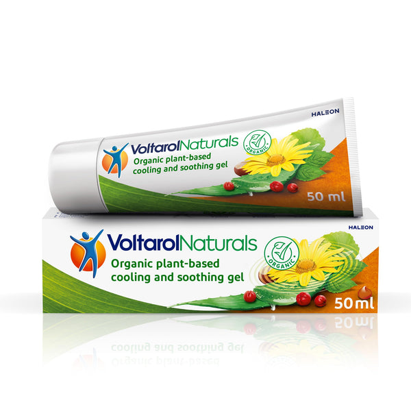 A tube of Voltarol Naturals gel (50ml), vegan-friendly and plant-based, sits atop its box adorned with herbal imagery, emphasizing natural ingredients.