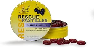 A round, yellow tin of Bach Rescue Remedy Soothing Pastilles Blackcurrant (50g) opens to reveal dark red, blackcurrant-flavored pastilles. This alcohol-free flower essence blend from Bach naturally relieves stress, with a few pastilles scattered invitingly in front.