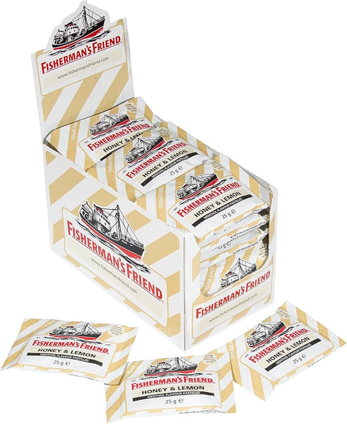 A box of Fishermans Friend Honey and Lemon Menthol Lozenges 25g (24 Packs) is shown, with several individual yellow and white striped packets around it. The Fishermans Friend packaging features a drawing of a ship.