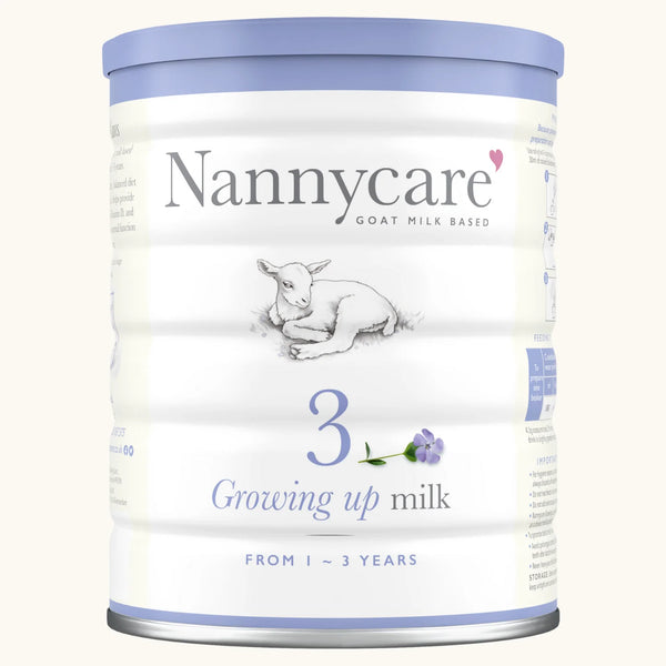 A 900g tin of NannyCare Growing Up Milk 3, a goat milk formula for children aged 1–3 years from Nannycare, features a baby goat, purple flower, and 3 Growing up milk on its front label.