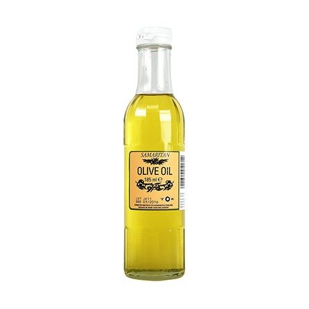 A clear glass bottle labeled Samaritan Olive Oil (185ml) contains premium golden olive oil ideal for natural remedies. It features olive graphics, a white cap, and a side barcode.