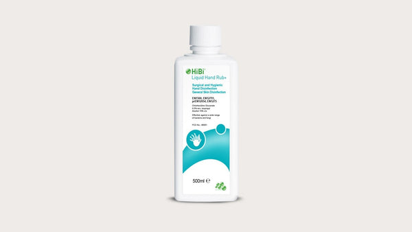 The 500ml bottle of Hibi Liquid Hand Rub+ by Molnlycke features a white body and turquoise label with hand hygiene symbols. It acts as an antimicrobial barrier thanks to chlorhexidine gluconate. The sealed cap is set against a light gray backdrop.