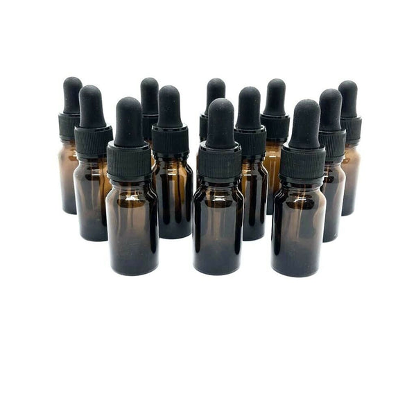 A set of twelve Amber Glass Pipette Dropper Bottles (20ml) with black caps is neatly arranged on a white background, ideal for storing light-sensitive liquids and ensuring UV protection.