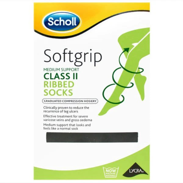 Box of Scholl Softgrip Class 2 Ribbed Compression Socks 18-24mmHg (Black, Medium), showing a leg with a green ribbon. Packaging highlights healthy circulation for varicose veins and edema, featuring the Lycra logo.