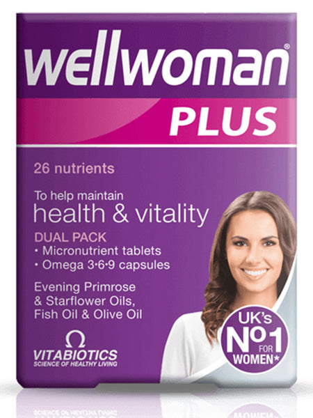 A box of Vitabiotics Wellwoman Plus Dual Pack (28 Tablets/28 Capsules) features a smiling woman and “26 nutrients,” “health & vitality,” and “UK’s No.1 for women” on its purple packaging with white and pink accents.