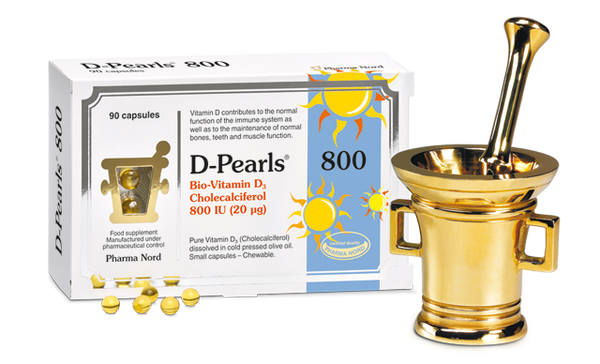 Pharma Nords Pharmanord Bio-Vitamin D3 (800 IU) with 80 capsules is displayed beside a gold mortar and pestle. The packaging features a sun logo and highlights the vitamins benefits, like improved calcium absorption when taken with olive oil.