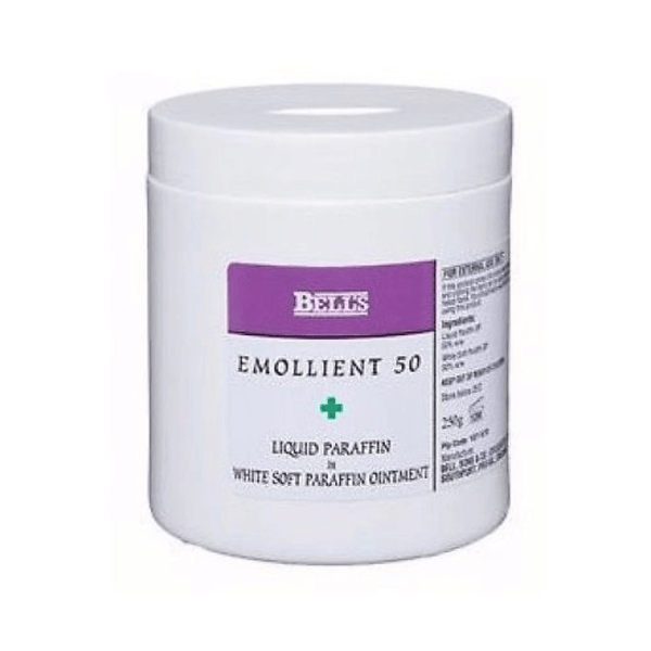 A white container labeled Bells Emollient 50 (500g) in a purple and white design, ideal for soothing dry and sensitive skin, contains Liquid Paraffin & White Soft Paraffin Ointment and is by Bells, with some text on the side partially visible.