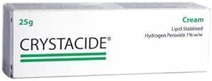 The image shows a box of Crystacide Cream (25g), containing 1% w/w lipid-stabilized hydrogen peroxide as an antiseptic. The mostly white packaging is highlighted with green text and stripes.