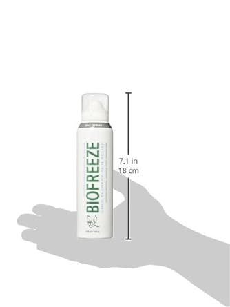 The Biofreeze Pain Relieving Spray (118ml) by Biofreeze is shown, designed for cryotherapy-based pain relief. A hand silhouette suggests its size at 7.1 inches or 18 centimeters tall. The sleek white can, with green and black text, emphasizes its effectiveness in soothing discomfort.