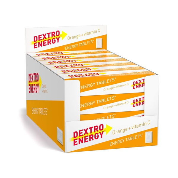 A box of Dextro Energy Tablets-Orange (24 pack) offers a vitamin-C boost arranged neatly. The vibrant orange and white packaging features bold red and yellow text, making it your perfect dextrose fix for an instant energy boost.