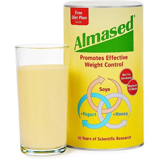 A 500g can of Almased Meal Replacement Powder stands beside a shake glass. The yellow packaging emphasizes natural ingredients—soya, yogurt, honey—and features 30 Years of Scientific Research. Ideal as a meal replacement for effective weight control.