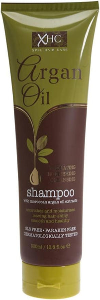 A 300ml tube of Argan Oil XHC Shampoo features a brown and green design and is enriched with Moroccan Argan Oil and Vitamin E. It moisturizes, is SLS-free, paraben-free, dermatologically tested, and ideal for reviving dry damaged hair.