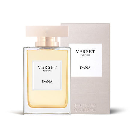 A 100ml bottle of Verset Dana features a transparent rectangular glass design with a pale gold cap, standing next to its matching white and beige box. The light golden perfume inside hints at the floral fragrance of ylang ylang and grapefruit.