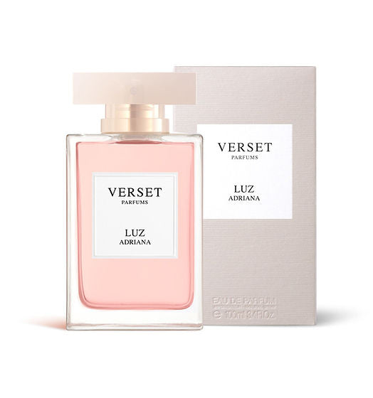 The 100ml Verset Luz Adriana bottle, filled with pink liquid, boasts a minimalist white label with black text. Presented in front of its neutral-toned box featuring consistent branding, it exudes an oriental floral allure.