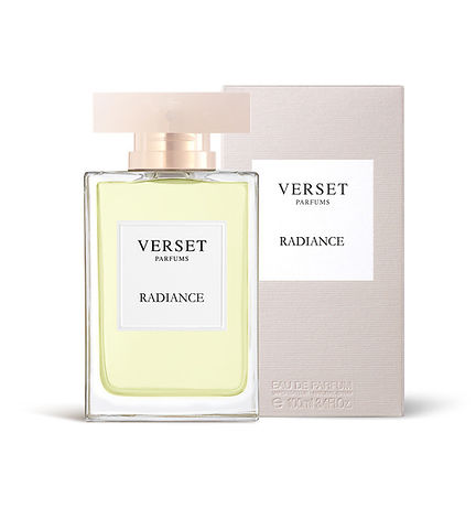 A clear bottle of Verset Radiance (100ml) perfume holds a light yellow liquid, reflecting its Oriental Woody notes. It has a square label, wide flat cap, and is paired with a matching rectangular box.