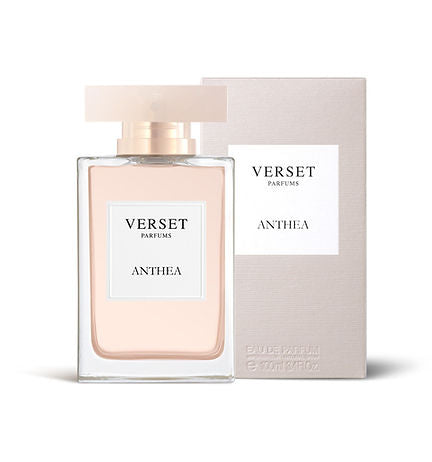 A rectangular bottle of Verset Anthea perfume with a translucent cap stands before its matching box. Both display Verset Anthea by Verset. The light pink liquid suggests tuberose notes within its fragrance.