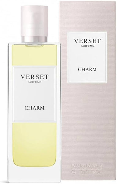 A 50ml rectangular Verset Charm perfume bottle stands by its matching light pink box, both adorned with minimalist white labels and black text showing the Verset brand and fragrance name.