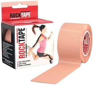 A roll of RockTape Kinesiology Tape Beige (5cm X 5cm), with hypoallergenic adhesive, is shown next to the red and black box that features a person using the elastic tape on their shoulder and knee, along with key product information.