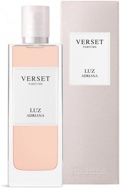 A 50ml bottle of Verset Luz Adriana stands before its matching light pink box, featuring clear glass with pale pink liquid and a white label showing the Verset brand and fragrance name.
