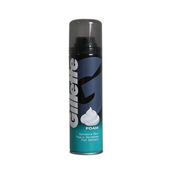 The Gillette Classic Sensitive Skin Shaving Foam (200 ml) features a sophisticated blue and green design with a grey cap and white swirl graphic. It offers a smooth shave with its Comfort Glide Formula, while FOAM is displayed under the iconic Gillette logo.