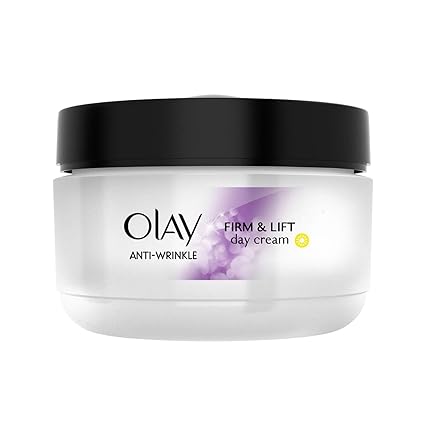 A white jar of Olay Anti-Wrinkle Firm & Lift Day Cream (50ml) with a black lid features a purple design and yellow symbol. Infused with niacinamide and SPF 15 for enhanced anti-aging benefits.