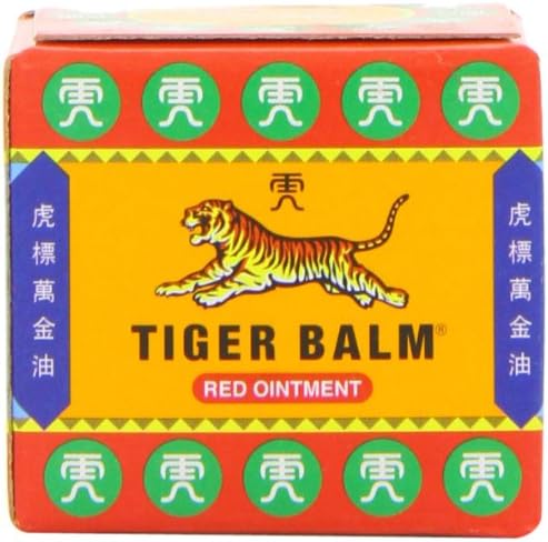 The 19g box of Tiger Balm Red Ointment by Tiger Balm features a tiger illustration on a vibrant yellow background, highlighted with green circles and Chinese characters. The words TIGER BALM and RED OINTMENT promise soothing relief from muscle pain using trusted herbal ingredients.