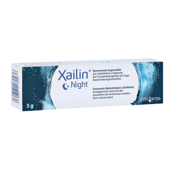 Xailin Night Eye Ointment (5g) comes in packaging featuring a water splash design with German and French text, emphasizing relief for dry eyes. This soothing, preservative-free ointment is ideal for nighttime use.