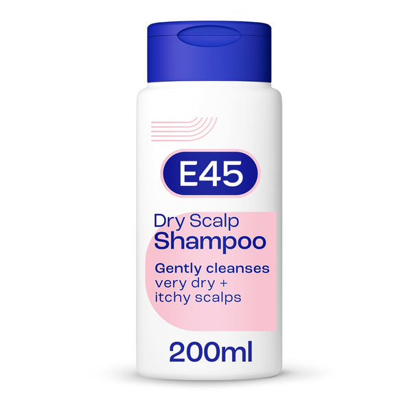 A white bottle of E45 Dry Scalp Shampoo 200ml has a blue cap, with a label that reads Gently cleanses very dry + itchy scalps. It features pink and blue design elements and is enriched with ProVitamin B5. This dermatologically tested formula offers gentle care for your scalp.