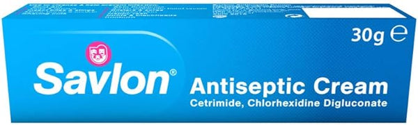 A 30g blue box of Savlon Antiseptic Cream prominently displays the Savlon brand name and logo, highlighting cetrimide and chlorhexidine digluconate for trusted protection.