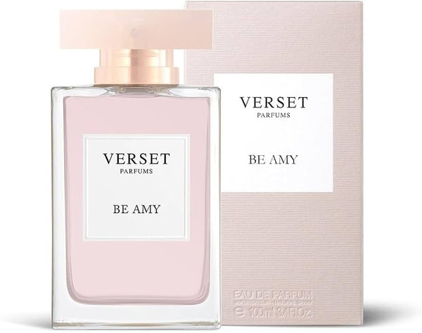 A bottle of Verset Be Amy (100ml) by Verset stands before its matching light pink box, featuring a rectangular design with soft pink liquid and a clear cap, reflecting the fragrance’s subtle sophistication.