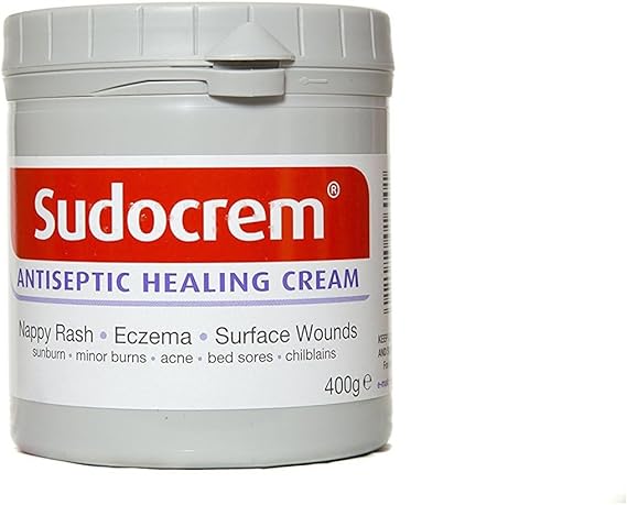 The 400g Sudocrem Sudo Cream is an antiseptic healing cream with a red and white label, ideal for treating nappy rash, eczema, sunburn, minor burns, acne, bed sores, and chilblains.