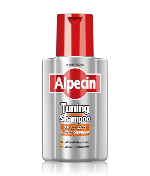 A metallic silver bottle of Alpecin Tuning Shampoo 200ml with a red cap features the brand name in white on red. The German caffeine shampoo is designed to enhance dark hair color and stimulate hair roots, making it ideal for thinning hair and growth concerns.