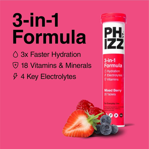 A red and white tube labeled Phizz Mixed Berries Red (20s) by Phizz claims faster hydration with vitamins, minerals, and electrolytes. Surrounded by strawberries, blueberries, and raspberries, it is set against a vibrant pink background as an effervescent tablet.