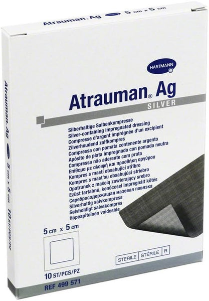 Atrauman Ag Dressing (5cm x 5cm) in a mainly white package features blue and gray text highlighting its antibacterial silver content, with a dressing corner shown at the bottom right.