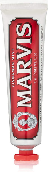 The Marvis Cinnamon Mint toothpaste, with an 85 ml red and white tube featuring the brands logo, offers a refined blend of floral and fruity notes labeled dentifricio and toothpaste in multiple languages for a sophisticated oral care experience.