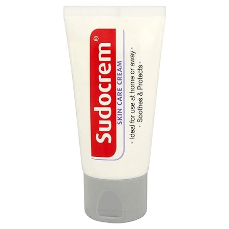 A compact, 30g Sudocrem Skin Care Cream tube with a red/white label and gray cap, ideal for skincare routines. Ideal for use at home or away. Soothes & protects spot-prone skin is printed on it, perfect for eczema, nappy rash, and minor burns.