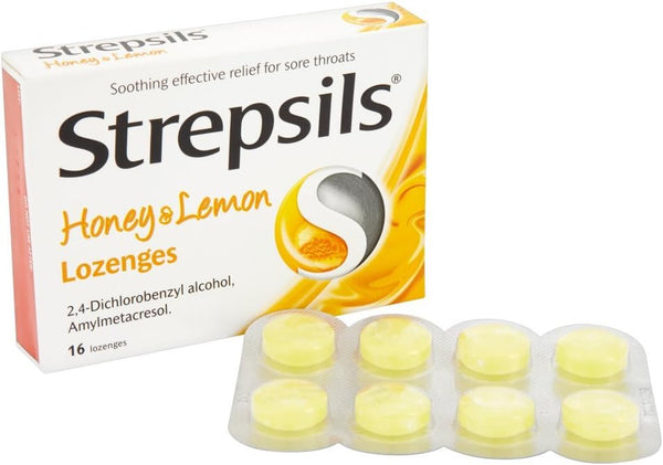 A box of Strepsils Honey & Lemon Lozenges (16) by Strepsils, featuring soothing relief for sore throats, with a blister pack of yellow lozenges in front.