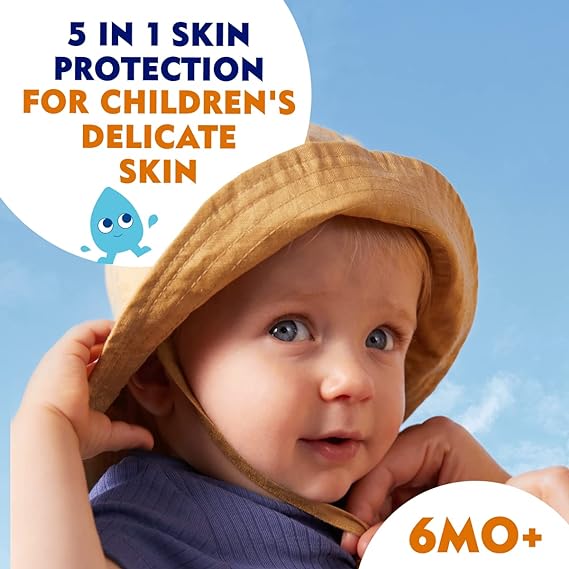 A baby in a yellow sun hat looks at the camera under a blue sky, showcasing Nivea Sun Kids Sensitive Lotion SPF50+ (200ml) from Nivea. It offers 5 in 1 skin protection with extra water-resistant UVA/UVB protection for kids 6 months and older, featuring a cute small blue character on the design.