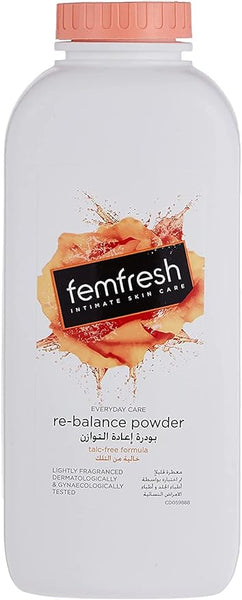 A bottle of Femfresh Intimate Hygiene Powder with a pink cap features an orange-accented label. It is talc-free, lightly fragranced, and dermatologically tested for personal freshness, with descriptions in English and Arabic.