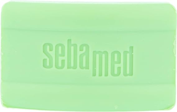 The Sebamed Cleansing Bar (150g) in light green is soap-free and perfect for sensitive skin, with sebamed embossed on its surface.