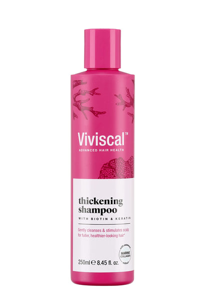 Viviscal Hair Thickening Shampoo (250 ml) by Viviscal is enriched with biotin and keratin, using natural ingredients to cleanse and stimulate the scalp. It features a pink bottle adorned with coral-like illustrations.