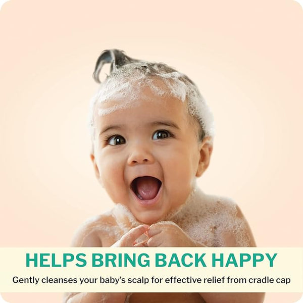 A smiling baby with shampoo bubbles on their head sits against a soft peach background. The text reads, Helps Bring Back Happy, highlighting Dentinox Cradle Cap Treatment (75ml) by Dentinox, a gentle formula designed for babys scalp care to relieve cradle cap.